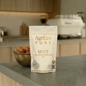 Ground Mace Spice by AgrEco Pure premium mace packaging displayed with whole mace blades in a modern kitchen setting